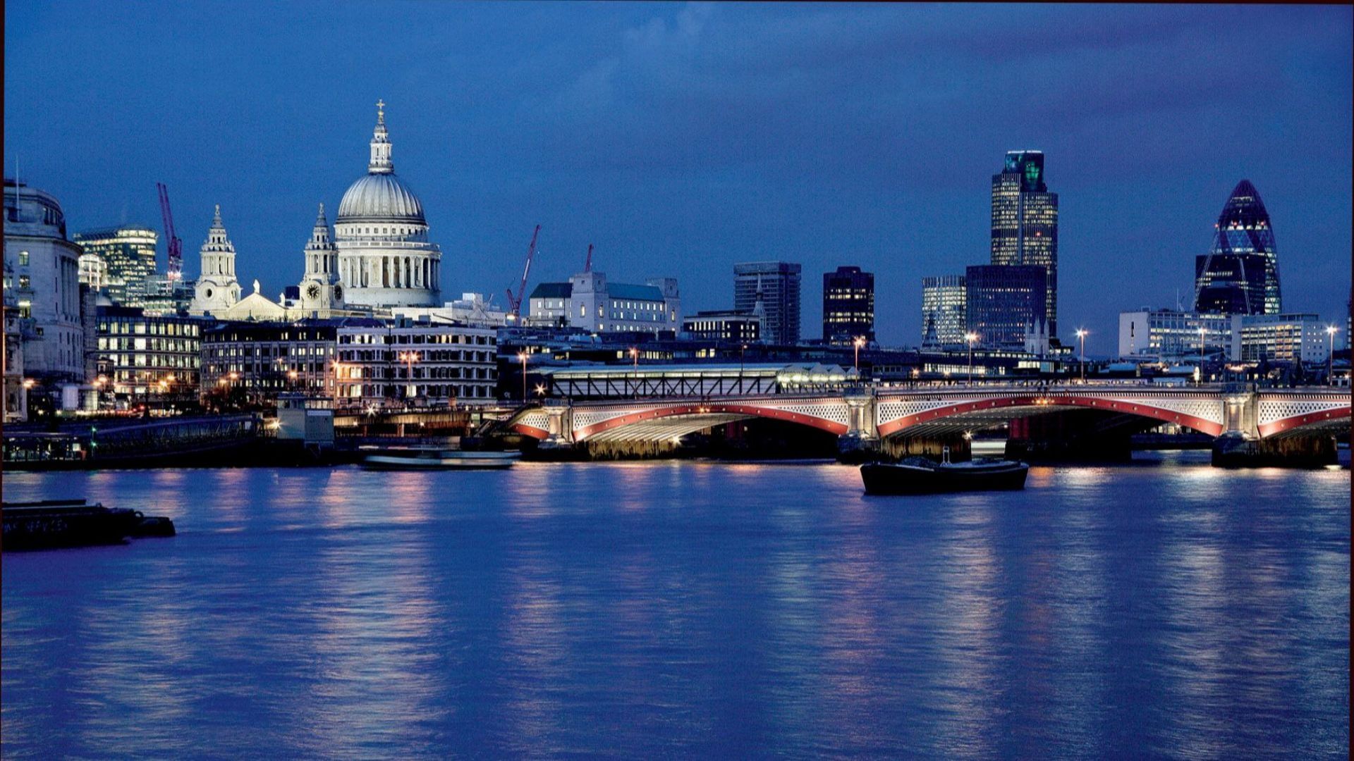 St Paul's Cathedral illuminated at night across the River Thames