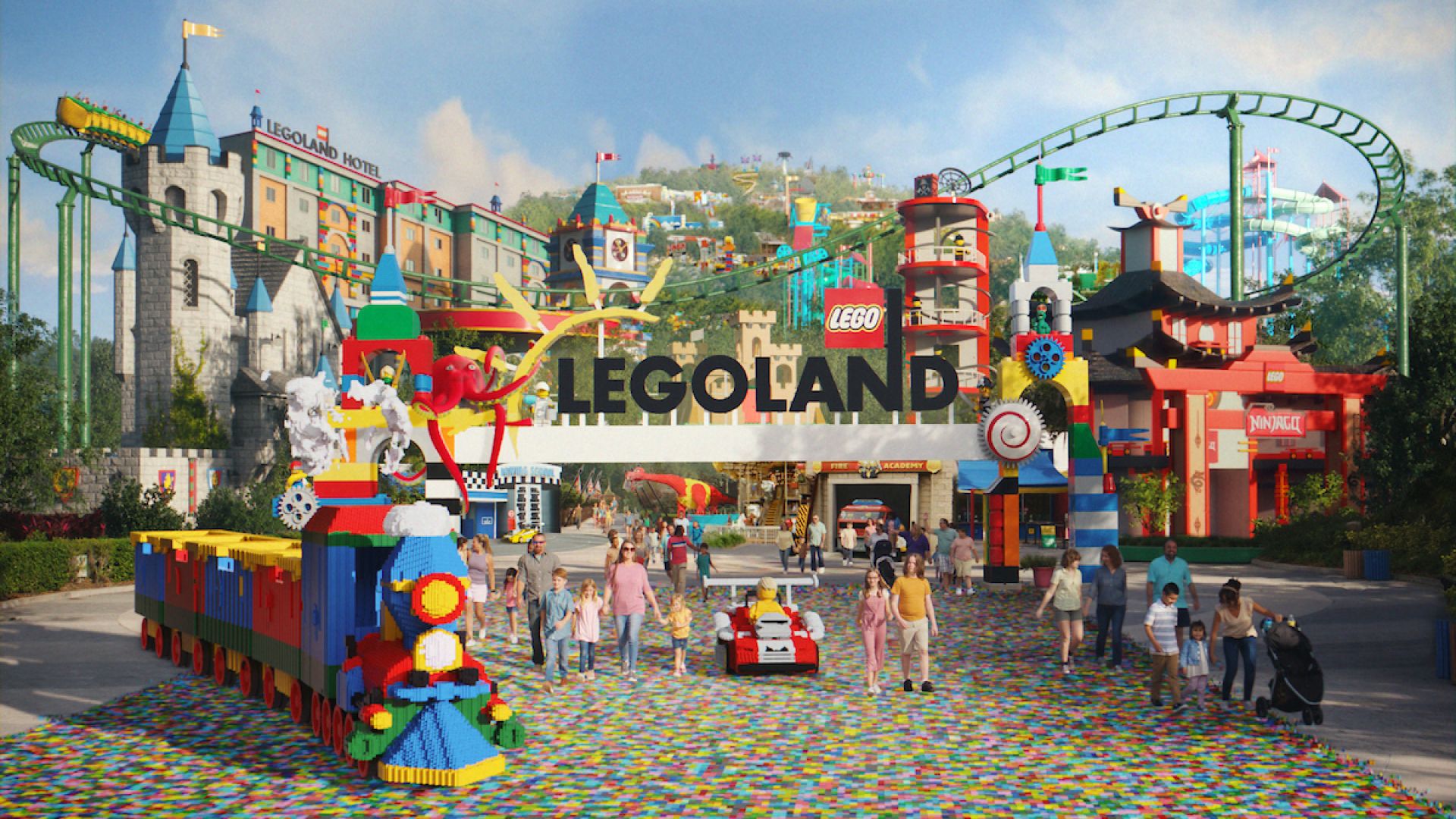 Colorful entrance to a LEGOLAND theme park with people walking nearby.